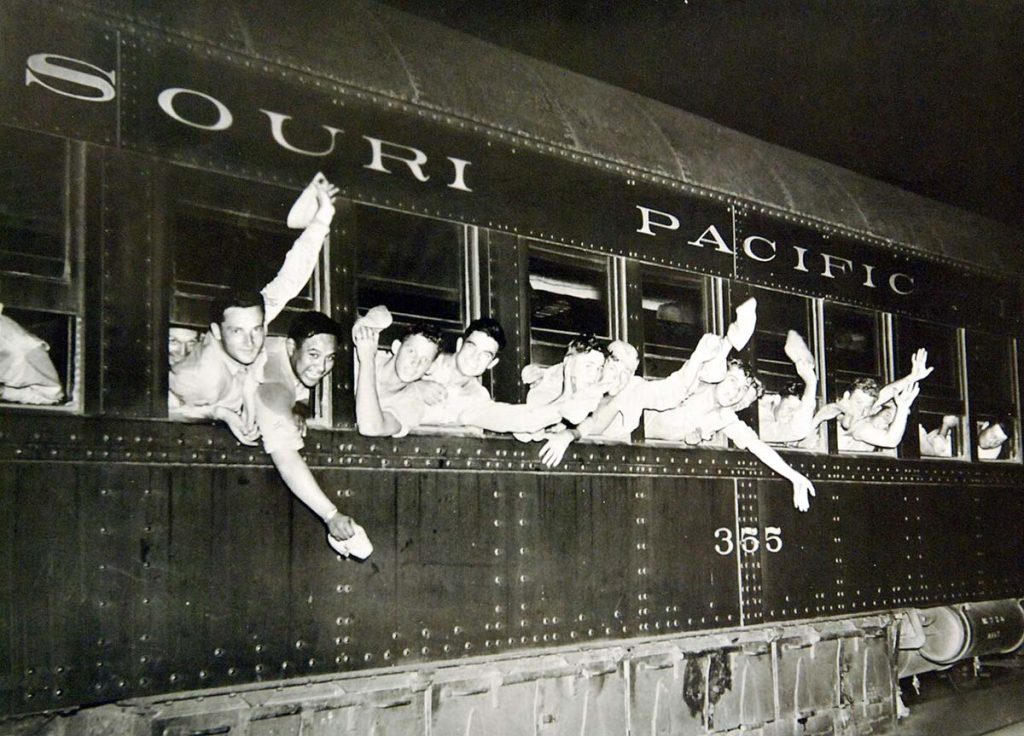 Troops leaving a training base in the Mid-west US during WW2 - Public domain image from Dept of Navy (US).