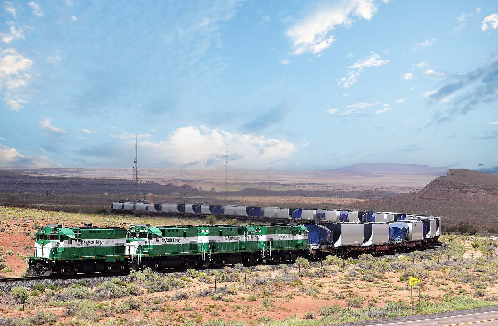 Apache Railway locomotives hauling mixed freight through rural Arizona landscape, showing first-mile and last-mile rail connections for regional industries